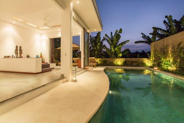 Swimming Pool And Open Lounge Area At Night