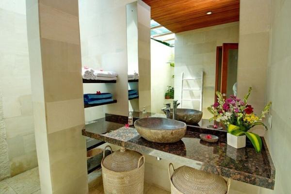 Flower Arrangement And Towels In The Bathroom