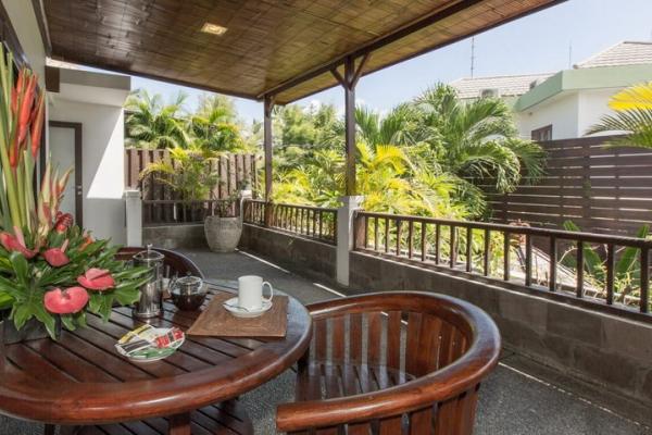 Chairs And Table With Flowers At The Balcony