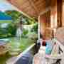 Shaded Sofa Overlooking The Pool