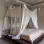 Bed With Mosquito Net In The Bedroom