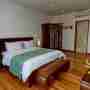 Bedroom 2 With AC Wooden Bed And Flower